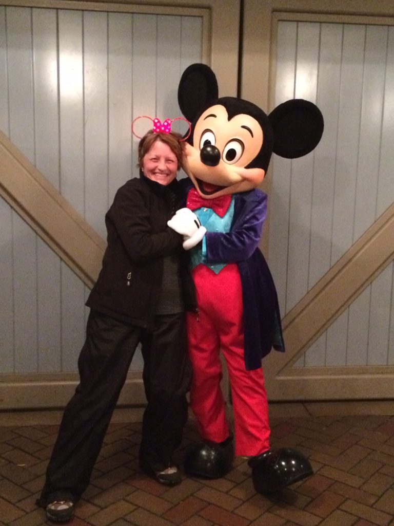 Tremendously Lucky Deborah Myers hugging Mickey Mouse at Disneyland